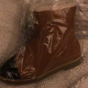 Tan suede boots with black toe and gold chain